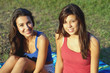 Pretty young female college students enjoying a campus field