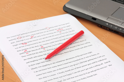 Photo: Proofreading a Manuscript beside Laptop Proofreading a Manuscript beside Laptop