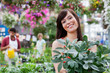Attractive female customer holding potted plant Attractive female customer holding potted plant