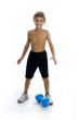 Photo: a boy in studio who raise a blue weight a boy in studio who raise a blue weight