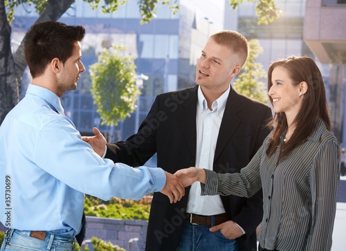 Photo: Businesspeople meeting outside of office Businesspeople meeting outside of office