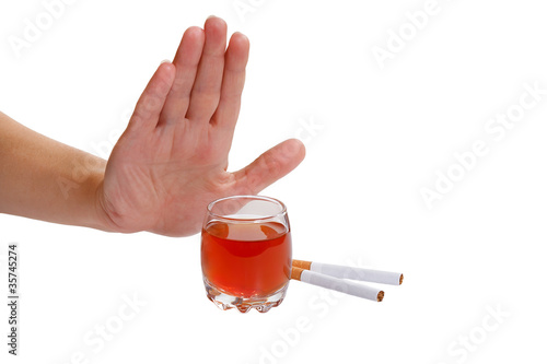 Photo: Hand rejects cigarette and alcohol. Stop smoking and drinking Hand rejects cigarette and alcohol. Stop smoking and drinking