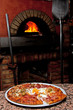 Photo: Ready-made pizza waiting in front of the oven Ready-made pizza waiting in front of the oven