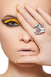 Model face with fashion make-up, big crystal ring. Disco makeup