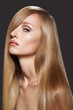 Woman model with shiny straight long blond hair, make-up