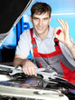 Foto: Master mechanic is satisfied with his job in a garage Master mechanic is satisfied with his job in a garage
