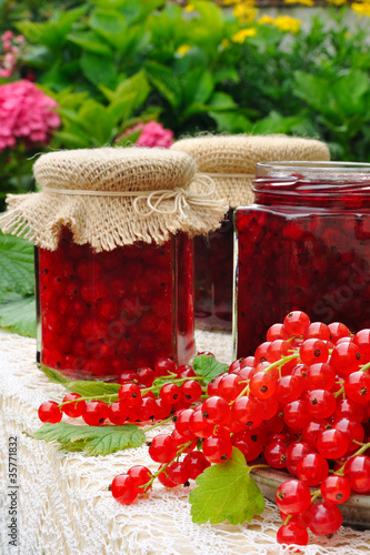 Photo: Jars of homemade red currant jam with fresh fruits Jars of homemade red currant jam with fresh fruits