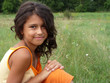 Portrait of a dark-haired girl in a meadow