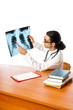 Male doctor looking at x-ray image