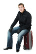 Businessman sitting on a suitcase.