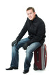 Businessman sitting on a suitcase.
