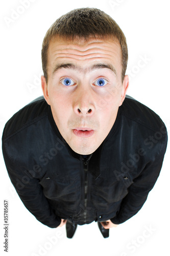 Photo: Funny man looks up on a white background. Funny man looks up on a white background.