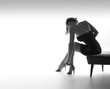 Sexy woman sits on chair, and prepares
