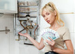 housewife counts up money for repair of a gas water heater.. housewife counts up money for repair of a gas water heater..