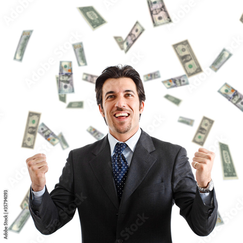 Photo: Happy man enjoying a rain of money Happy man enjoying a rain of money