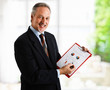 Handsome mature businessman showing a business plan
