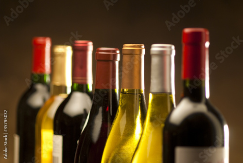Photo: Wine bottles in a row with limited depth of field Wine bottles in a row with limited depth of field