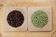 green and black peppercorns in wooden bowls, shallow dof green and black peppercorns in wooden bowls, shallow dof