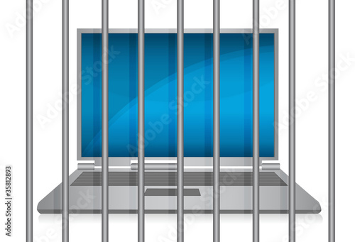 Photo: laptop behind bars. online crime concept laptop behind bars. online crime concept
