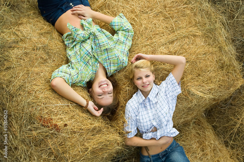 Photo: girls resting on hay girls resting on hay