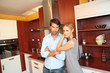 Happy young couple standing in home kitchen Happy young couple standing in home kitchen