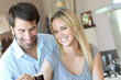 Happy young couple standing in home kitchen Happy young couple standing in home kitchen