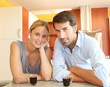 Happy young couple standing in home kitchen Happy young couple standing in home kitchen