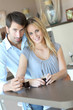 Happy young couple standing in home kitchen Happy young couple standing in home kitchen