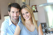 Happy young couple standing in home kitchen Happy young couple standing in home kitchen
