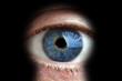 Man looking through keyhole