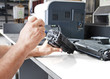 hands repairing toner cartridge
