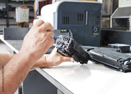 Photo: hands repairing toner cartridge hands repairing toner cartridge