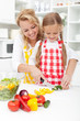 Slicing vegetables in kitchen Slicing vegetables in kitchen