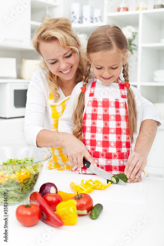 Photo: Slicing vegetables in kitchen Slicing vegetables in kitchen