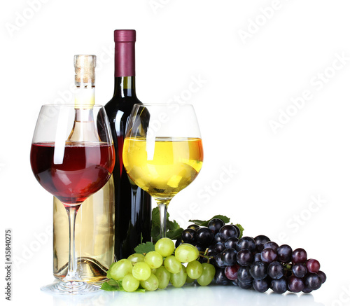 Photo: Ripe grapes, wine glasses and bottles of wine isolated on white Ripe grapes, wine glasses and bottles of wine isolated on white