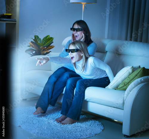 Photo: Mother with Daughter watching 3d film on TV Mother with Daughter watching 3d film on TV