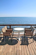 Idyllic cafe restaurant by the sea, on wooden deck