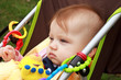 Staring baby being pushed in her stroller