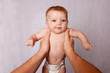 POV person holding baby with arms stretched