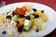 Foto: Greek salad on a white plate Greek salad on a white plate