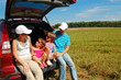 Family vacation. Parents with children in car trip