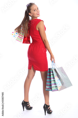 Photo: Beautiful woman in red dress has fun shopping Beautiful woman in red dress has fun shopping