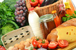 Groceries in wicker basket including vegetables and fruits Groceries in wicker basket including vegetables and fruits