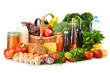 Groceries in wicker basket including vegetables and fruits Groceries in wicker basket including vegetables and fruits