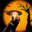 Halloween beautiful girl in dried tree bat