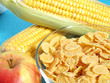 Apple, milk, and corn flakes close up