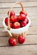 basket of red apples on wood floor basket of red apples on wood floor