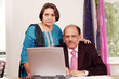Photo: Senior indian business couple in home office Senior indian business couple in home office