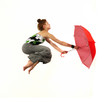 Girl jumping with red umbrella
