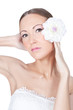 Young beautiful woman holding flower in her hands